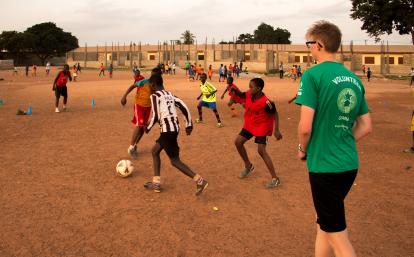 A Projects Abroad volunteer work with teens to teach football in Ghana. A sports player gains experience through volunteer football coaching in Ghana.